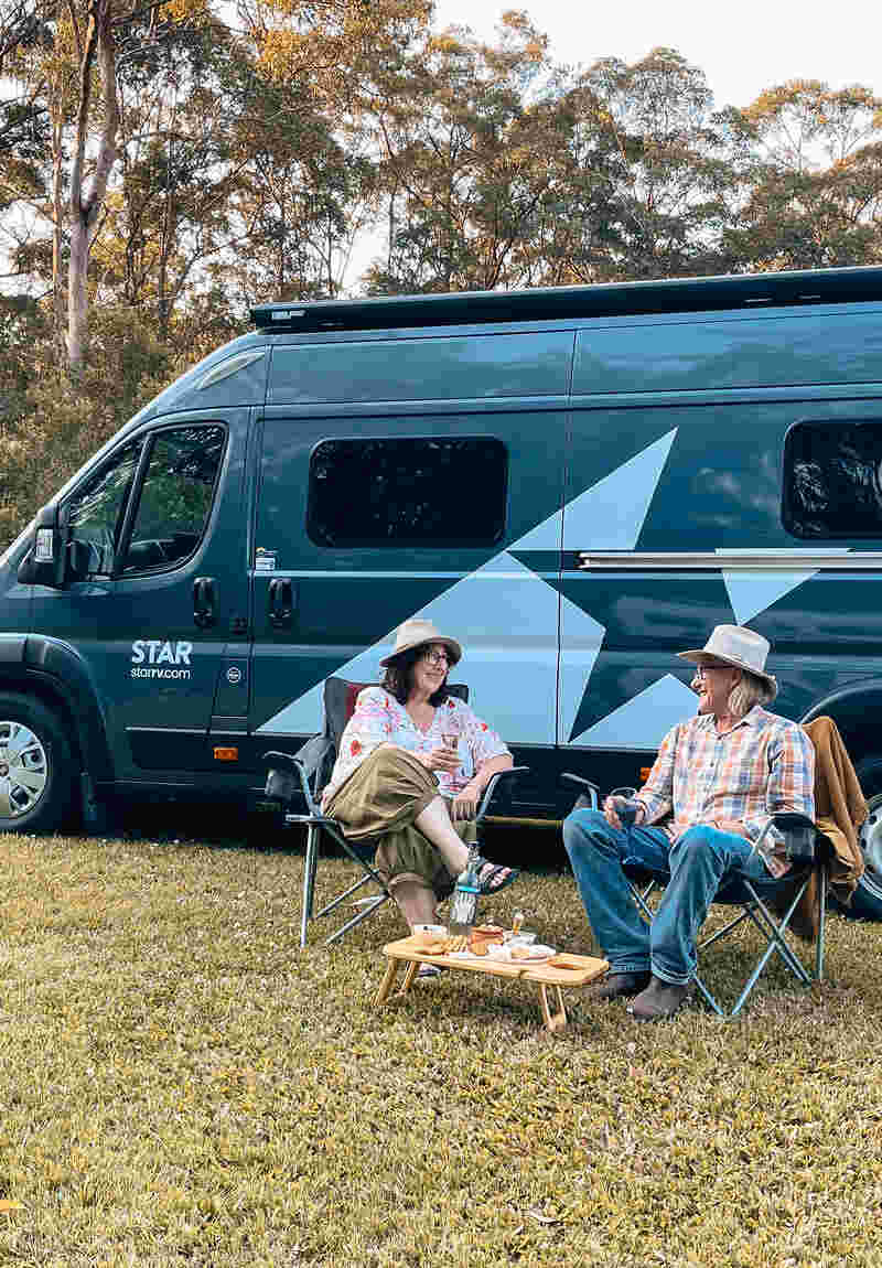 Older couple chilling by a Star RV Polaris 2 motorhome