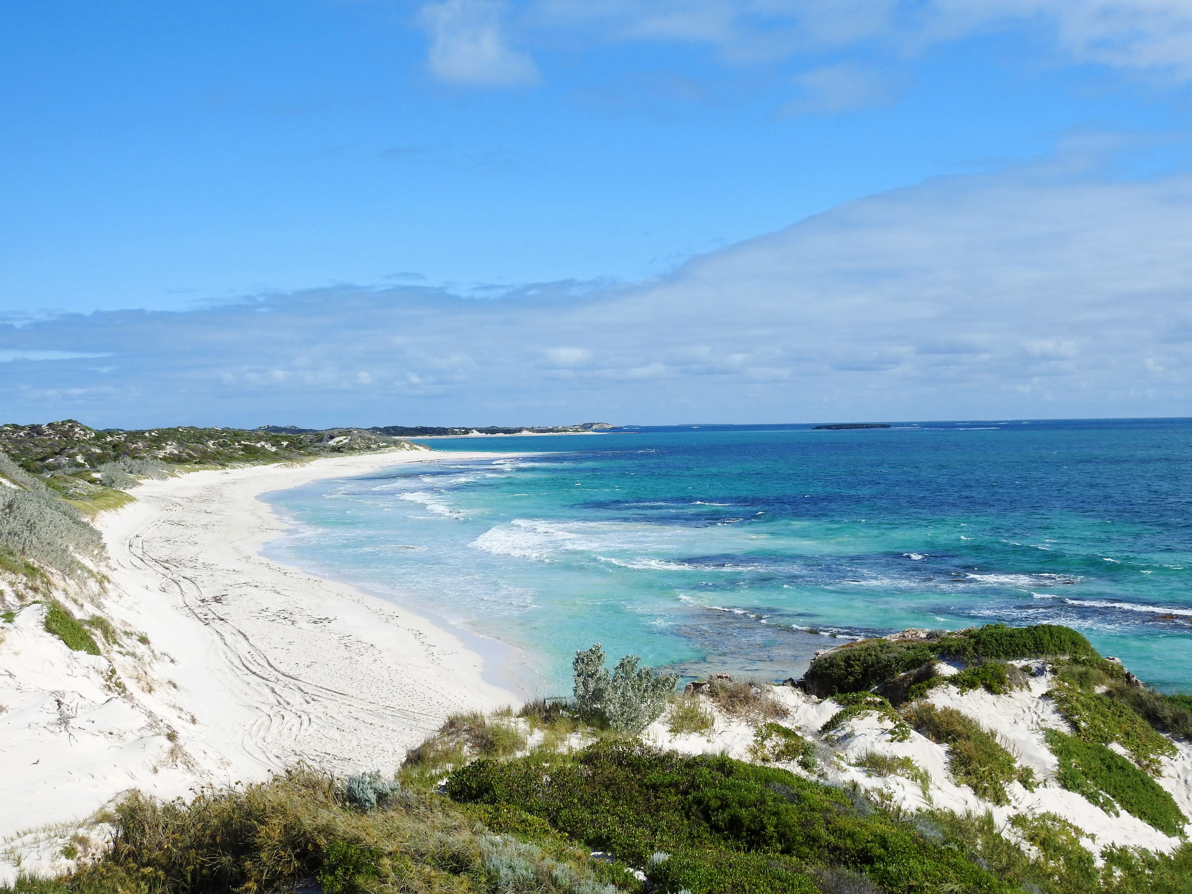 Expansive view of the Perth coastline with white sandy beach and turquoise waters under a clear blue sky. A wonderful free camping spot for Star RV motorhomes.